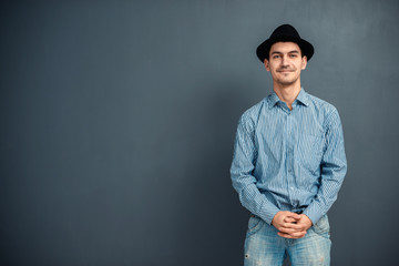 young man with a hat in the studio