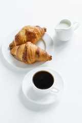 Breakfast. Coffee with milk and croissants. View from above.
