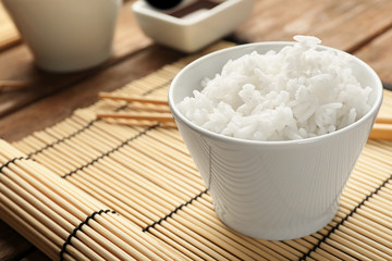 Bowl of rice on bamboo mat