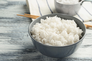Bowl of rice on wooden table