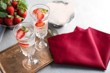 Glasses with delicious wine spritzer on golden tray