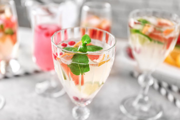 Glass of delicious wine spritzer on grey table