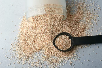 Rolgordijnen Spoon with quinoa seeds on table © Africa Studio