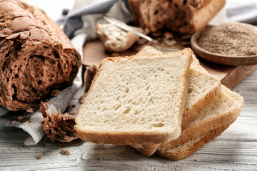 Fresh bread toasts on wooden table closeup