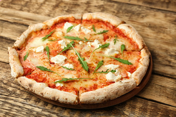 Fresh pizza Four Cheese on wooden background