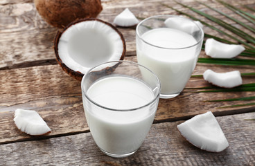 Composition with tasty coconut milk on wooden background
