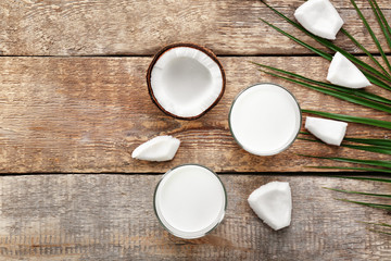 Composition with tasty coconut milk on wooden background