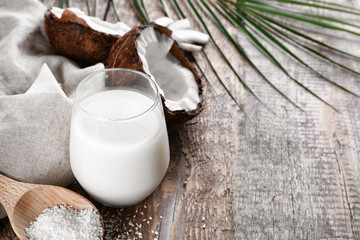 Composition with fresh coconut milk on wooden background