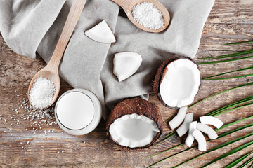 Composition with fresh coconut milk on wooden background