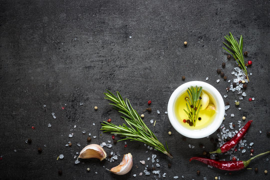 Olive oil rosemary salt pepper garlic. Food background. Cooking ingredients.