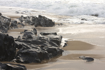 Rocks, beach, and sea-surf photographed at Kingsburgh beach in South Africa