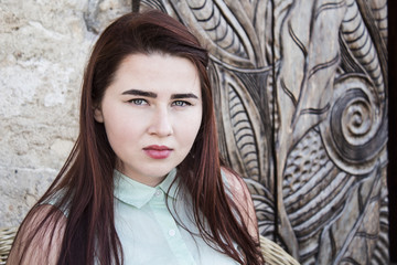 Fototapeta premium pretty young woman with dark long hair and blue eyes