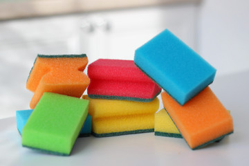 Multi-colored sponges on the kitchen table