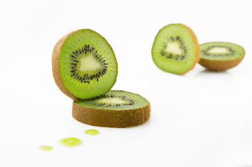 Fototapeta na wymiar Ripe and juicy kiwi fruit and its parts on a white background