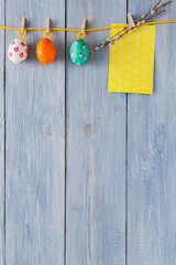 Colorful easter card and garland on wood background