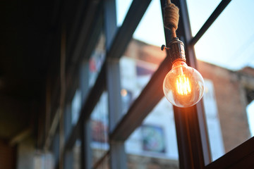 Beautiful retro style . Incandescent lamps in a modern cafe