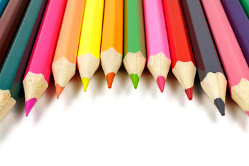 Colored pencils on a white background placed in a semicircle