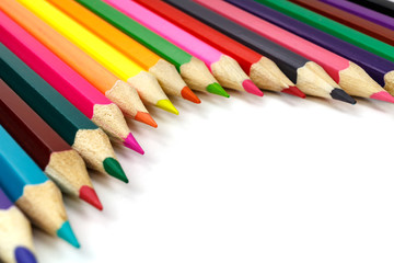 Wooden color pencils on a white background, view at an angle