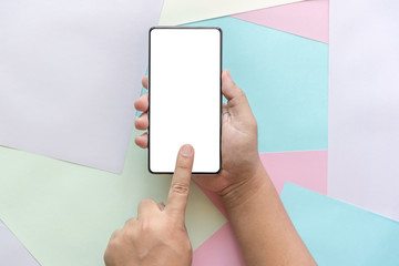 man hand holding the phone tablet on color paper background