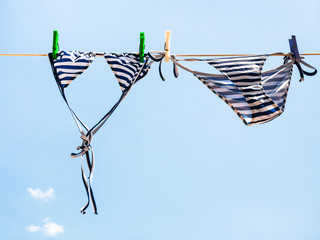 Striped swimsuit is dried on the clothesline