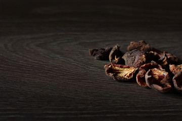 Various dried fruits: apricots, apple on a black background.
