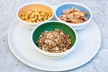 three bowls with cold breakfast cereals