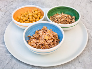 various cold breakfast cereals in bowls