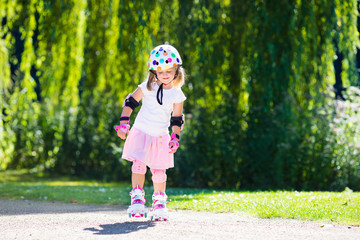 Little girl with roller skate shoes in a park