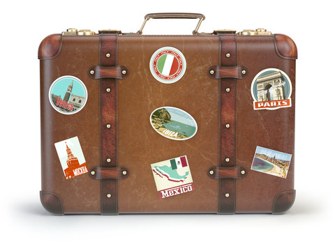 Vintage suitcase with travel stickers isolated on white background.