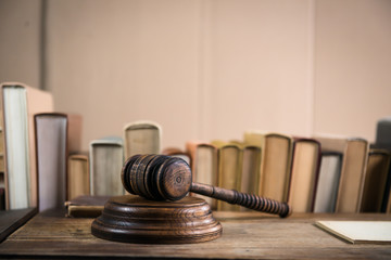 Law and Justice concept. Mallet of the judge, books, scales of justice. Gray stone background,...