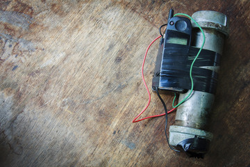 Steel pipe explosive (IED) is ignited by cell phone.For texture and background.