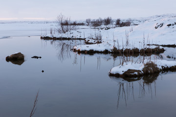 the shores of Lake Myvatn, Iceland at dusk