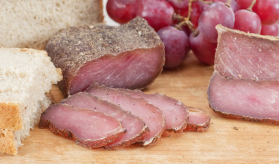 Sliced cured at home pork and spices with cumin