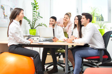 Group of young business people having meeting in modern office.