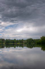 Fototapeta na wymiar Stormy clouds over lake