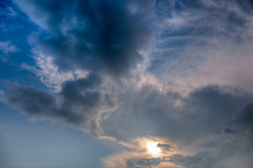 Naklejka na ściany i meble Cumulus clouds with rays of sun