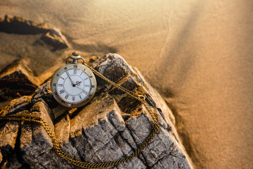 Vintage pocket watch on the beach