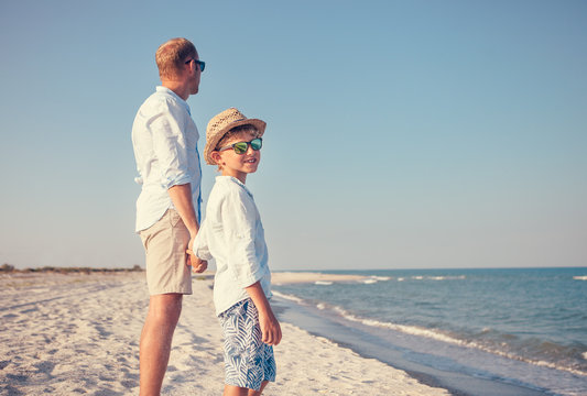 Father with little son stay on the sea beach