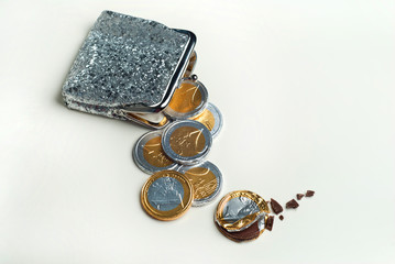 Shiny women's coin purse with chocolate euro coins in it