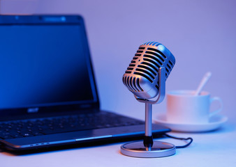 Retro microphone and notebook computer, live webcast concept