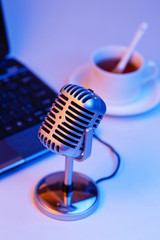Retro microphone and notebook computer, live webcast concept