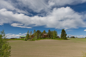Fototapeta premium Farmhouse on top of a hill