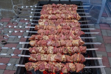 Skewers of pork on the coals with smoke. BBQ