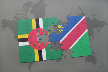 puzzle with the national flag of dominica and namibia on a world map