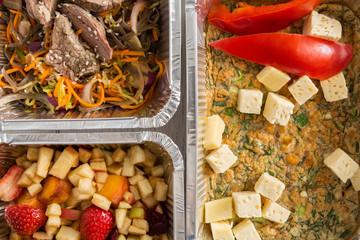 Healthy food take away, top view at wood background