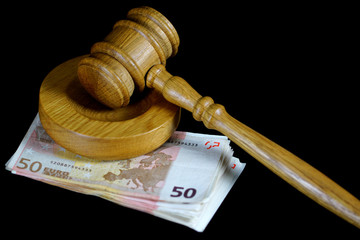 Gavel, book and bribe money on the table