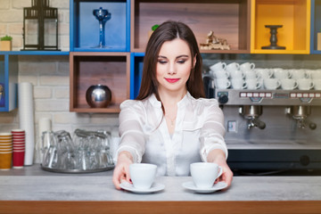 young girl preparing coffee in a cafe barista