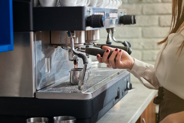 barista is preparing coffee on coffee machine