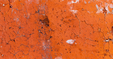 Cracked yellow brick with pieces of white plaster