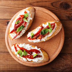 Italian sandwiches - bruschetta with cheese, tomato and basil. Top view